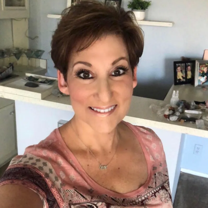Woman with short brown hair in a kitchen setting